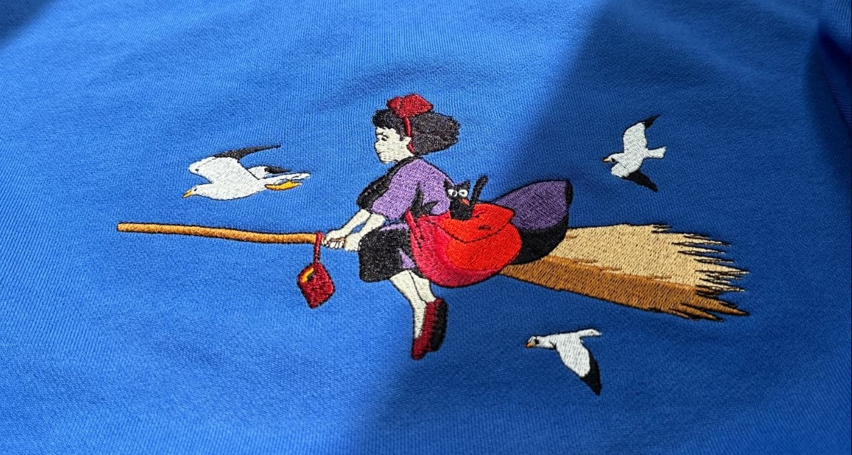 blue sweatshirt with color anime embroidered design of kiki  on top 